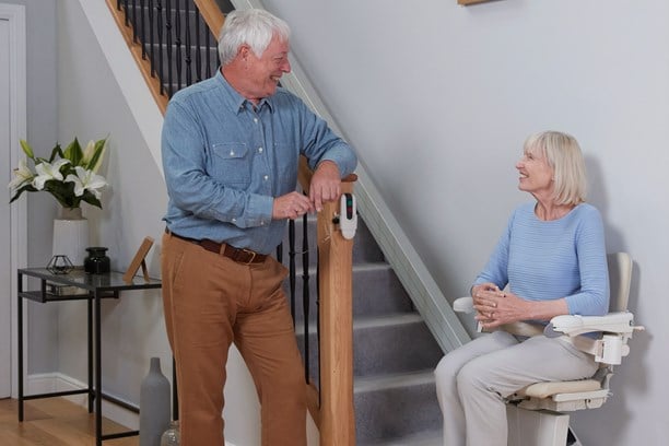 Woman on a stairlift looking at her husband