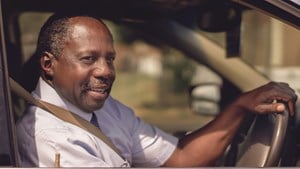 Smiling man driving car