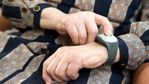 Close up of hands with personal alarm worn on wrist