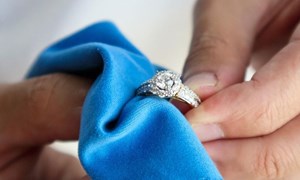 Diamond ring being polished with blue cloth