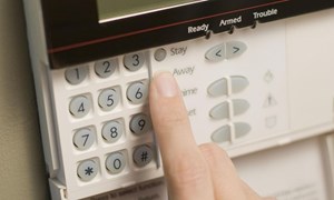 Code being entered into burglar alarm