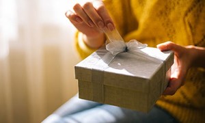 Present with ribbon being unwrapped