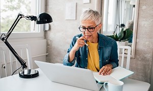 Woman working at desk on laptop