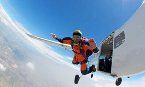 Skydiver jumping out of an airplane