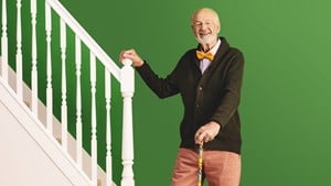 Harry stood next to a flight of stairs looking happy