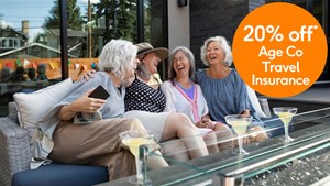 4 ladies laughing on a bench and drinking coctails