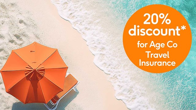 Aerial view of umbrella on beach next to a 20% discount roundel promo