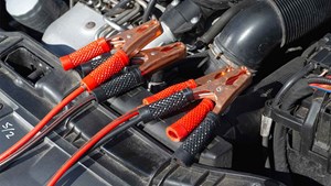 a car engine with jumper cables attached to it