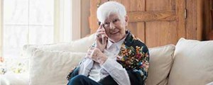 Woman talking on phone and sitting on sofa