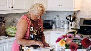 senior-lady-cooking-in-kitchen16-9-compressed