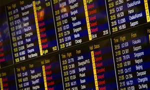 arrival and departure board at an airport showing delays across the board